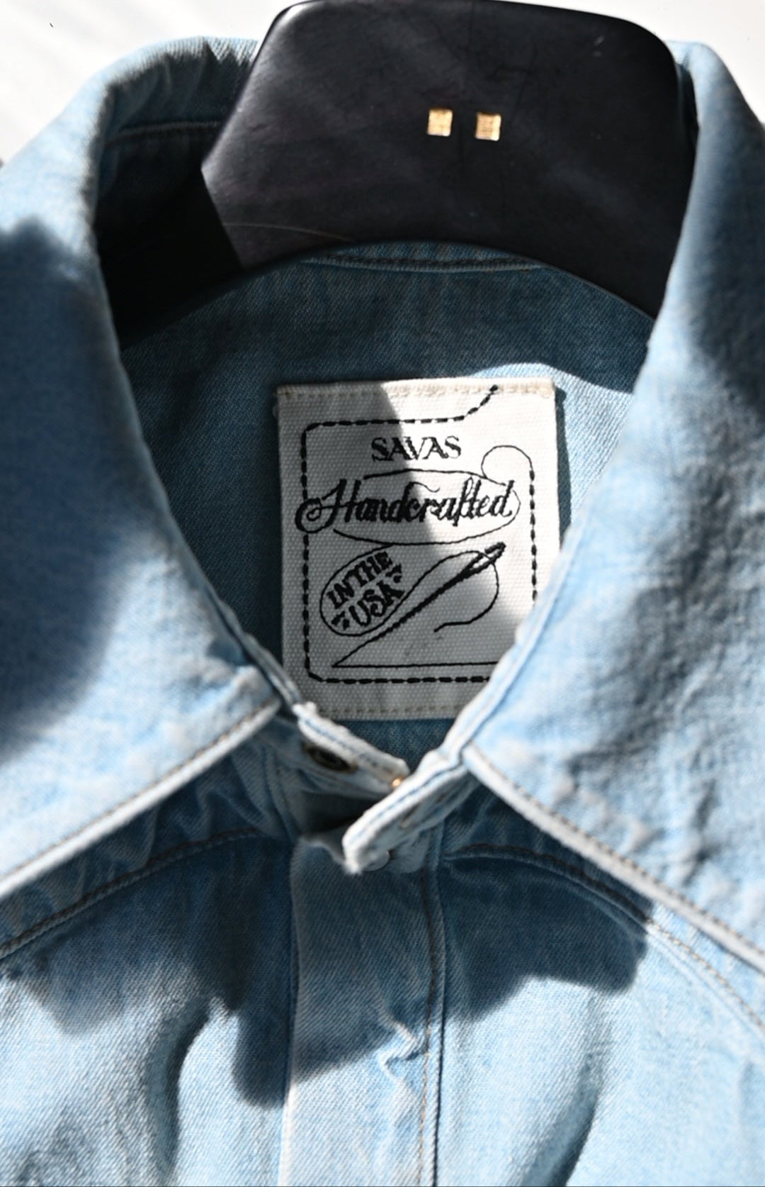 The Allen shirt in soft indigo denim, tailored fit with long sleeves and gold contrast stitching.