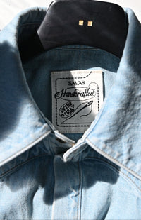 The Allen shirt in soft indigo denim, tailored fit with long sleeves and gold contrast stitching.