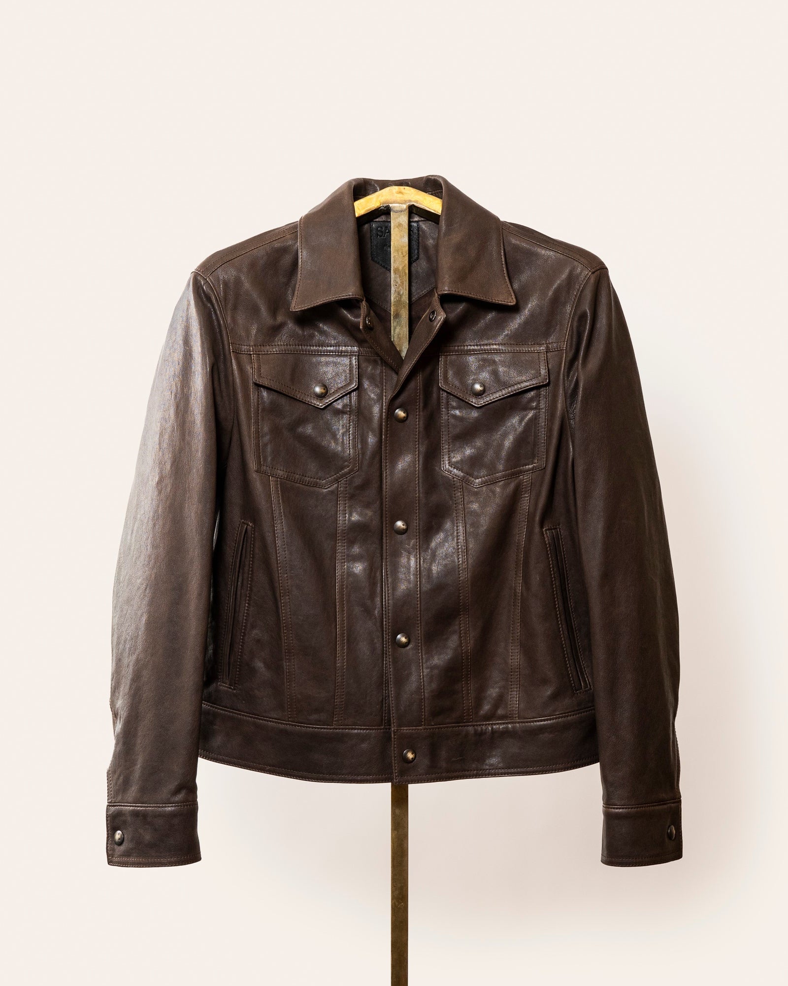 A softly tailored brown lamb leather jacket with a clean, versatile silhouette, gunmetal hardware, and smooth lining. Designed for everyday wear, adaptable from casual to refined styling.