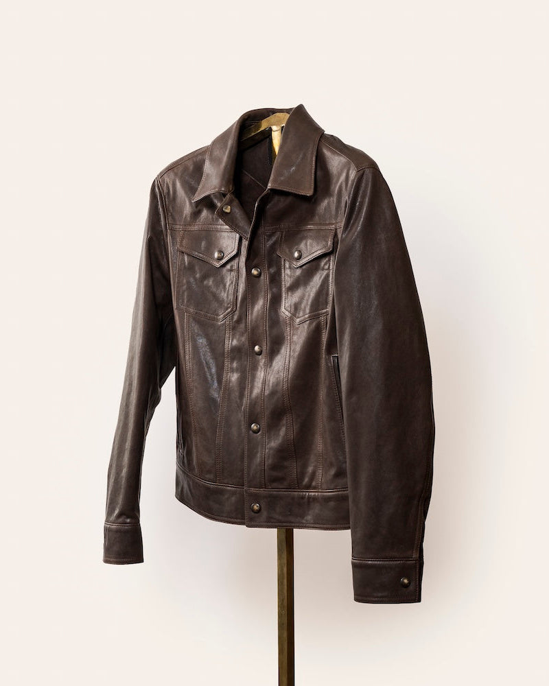 The Denham jacket by Savas in 100% lamb leather with gunmetal logo hardware, softly tailored fit, and Bemberg lining. A versatile black leather jacket that styles effortlessly with jeans or trousers.