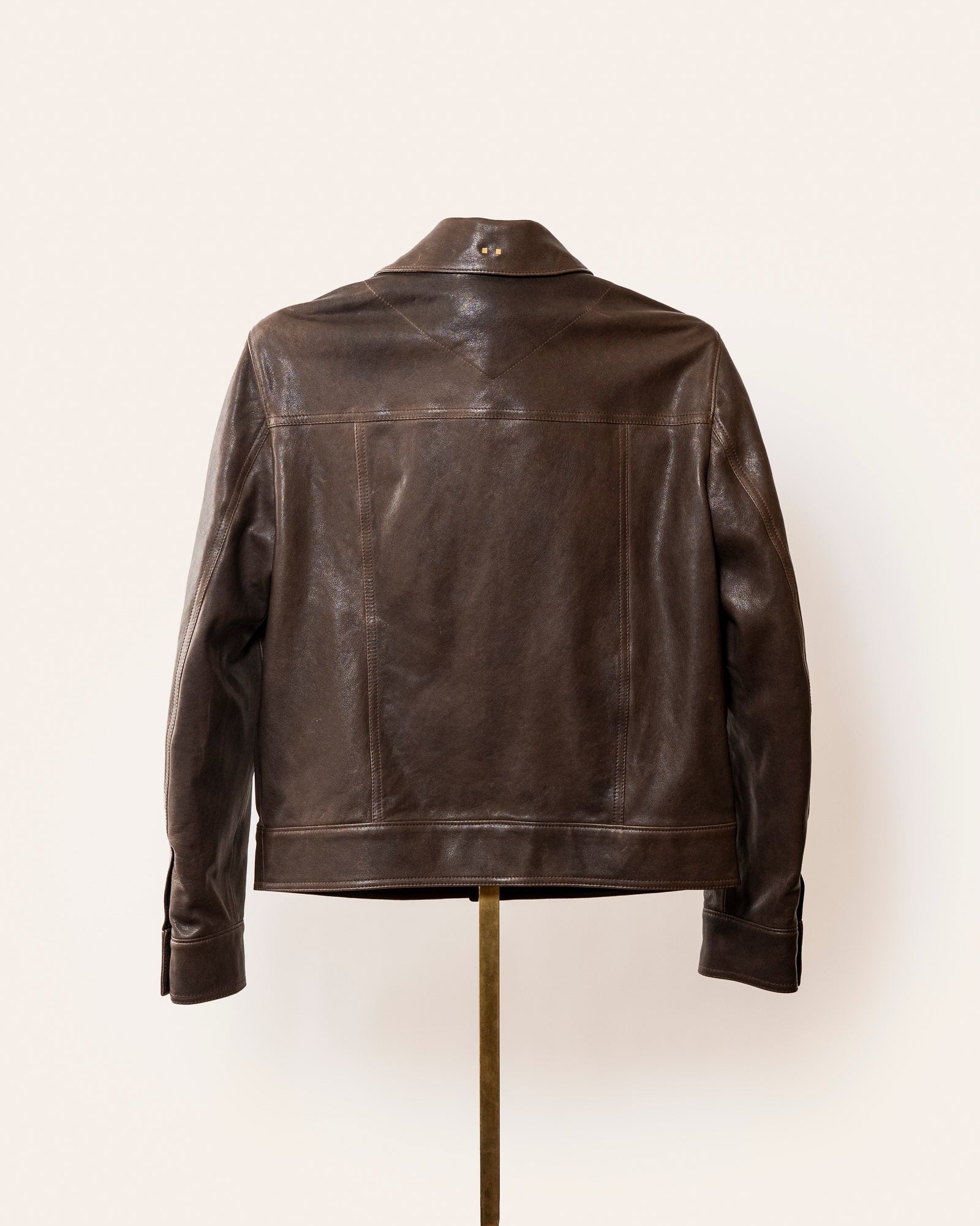 Luxury brown leather jacket, The Denham by Savas, featuring tailored cut, gunmetal logo hardware, and premium lining.