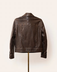 Luxury brown leather jacket, The Denham by Savas, featuring tailored cut, gunmetal logo hardware, and premium lining.