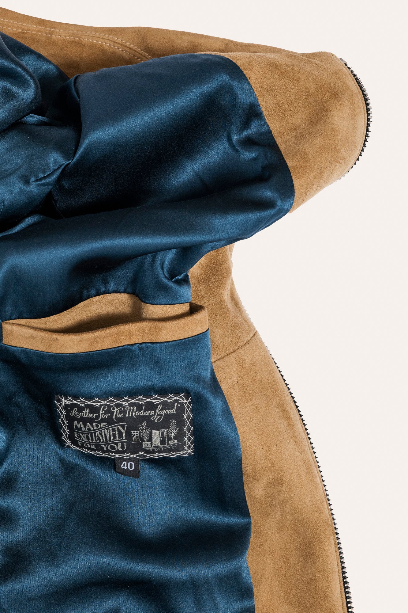 Luxury brown suede jacket with zipper accents and tailored fit