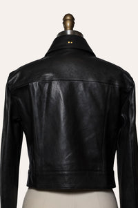 Black leather jacket on a mannequin against a white background