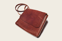 brown leather crossbody bag with handmade western wear details for men and women gift guide