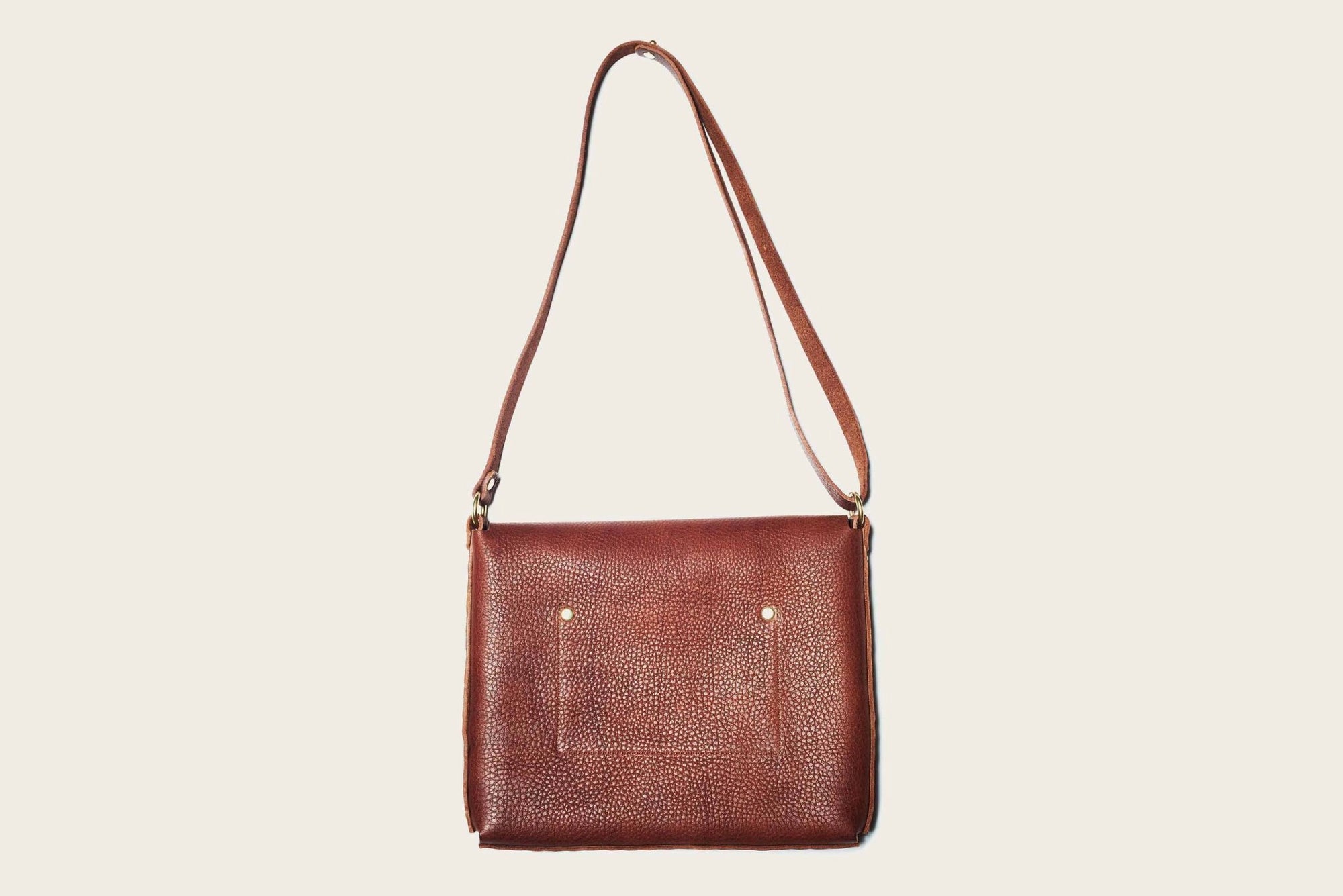 brown leather crossbody bag with strap featuring handmade western wear brass details by atelier savas in nashville tennessee