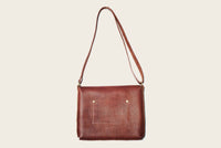 brown leather crossbody bag with strap featuring handmade western wear brass details by atelier savas in nashville tennessee