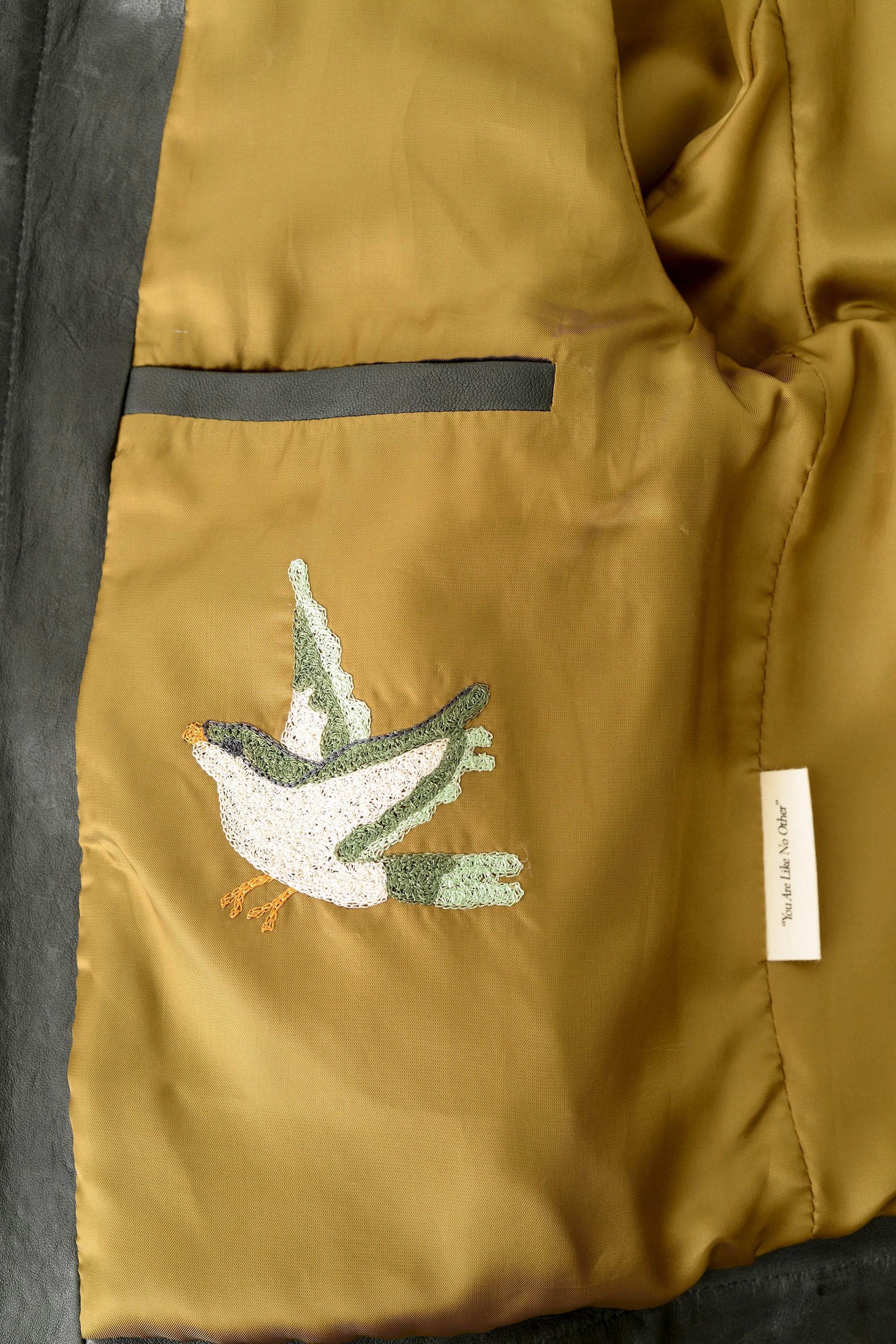 hand-embroidered bird on custom snap shirt jacket in grey leather by ateliers savs in nashville tennessee