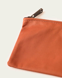 luxury leather clutch by atelier savas in orange with brass artisan made detail