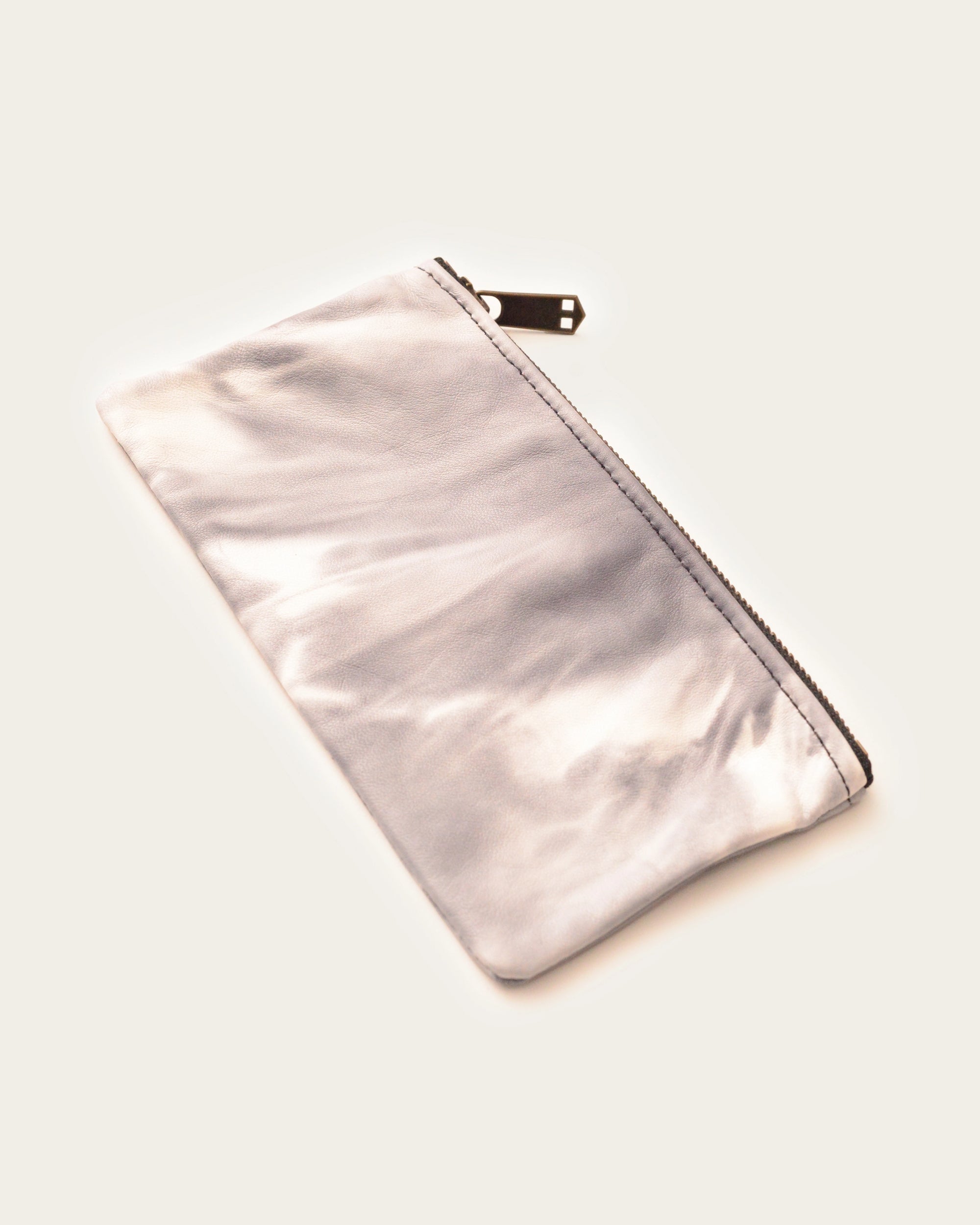 handmade leather clutch in tie dye print by luxury western wear brand atelier savas in nashville tennessee