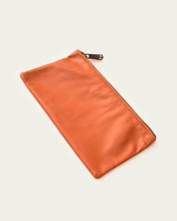 luxury apparel leather clutch in orange for womens gift guide by atelier savas in nashville tennessee