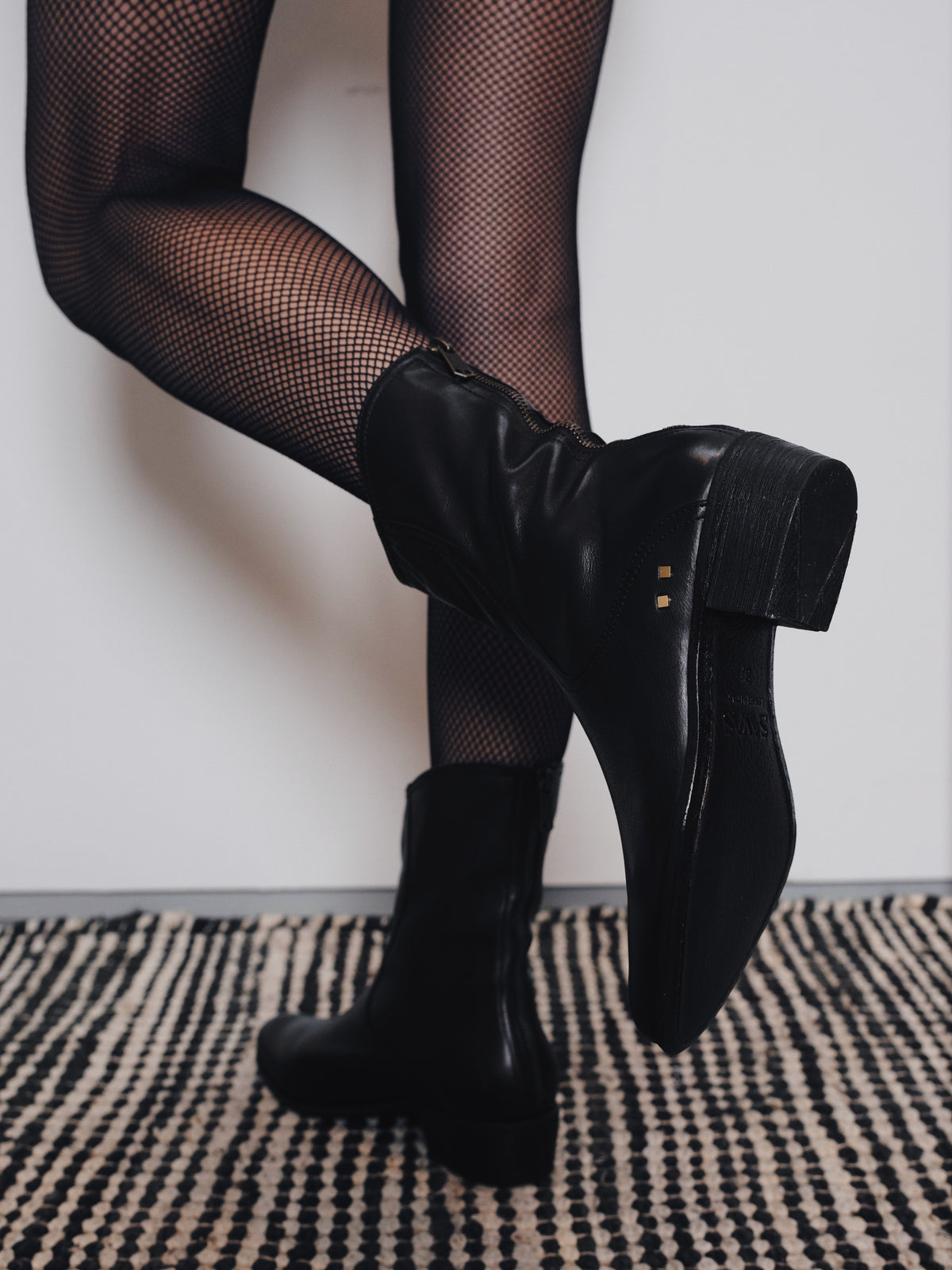 Image of a woman's feet posing in a pair of Savas boots.