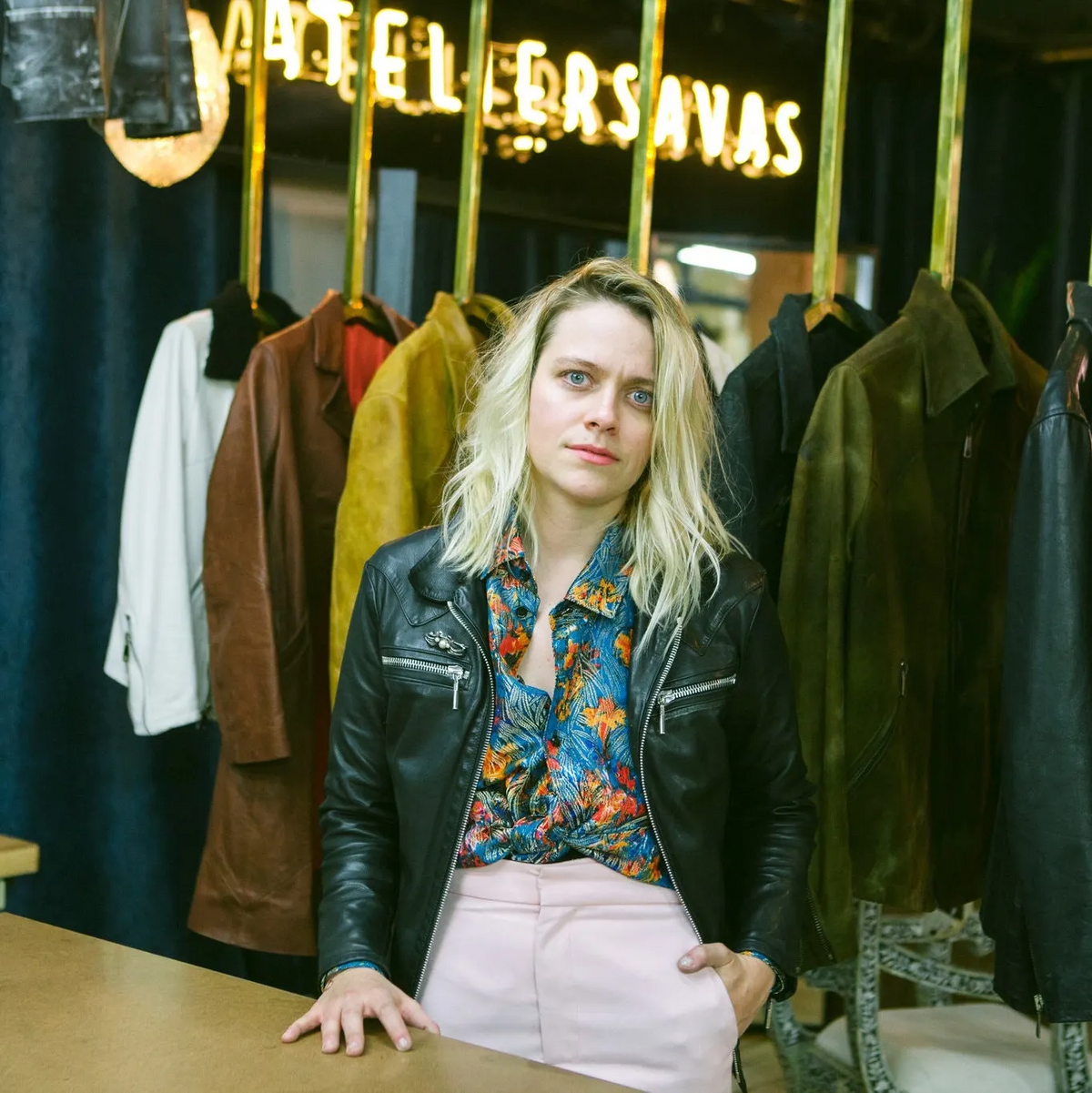 Savannah posing in front of several jackets.