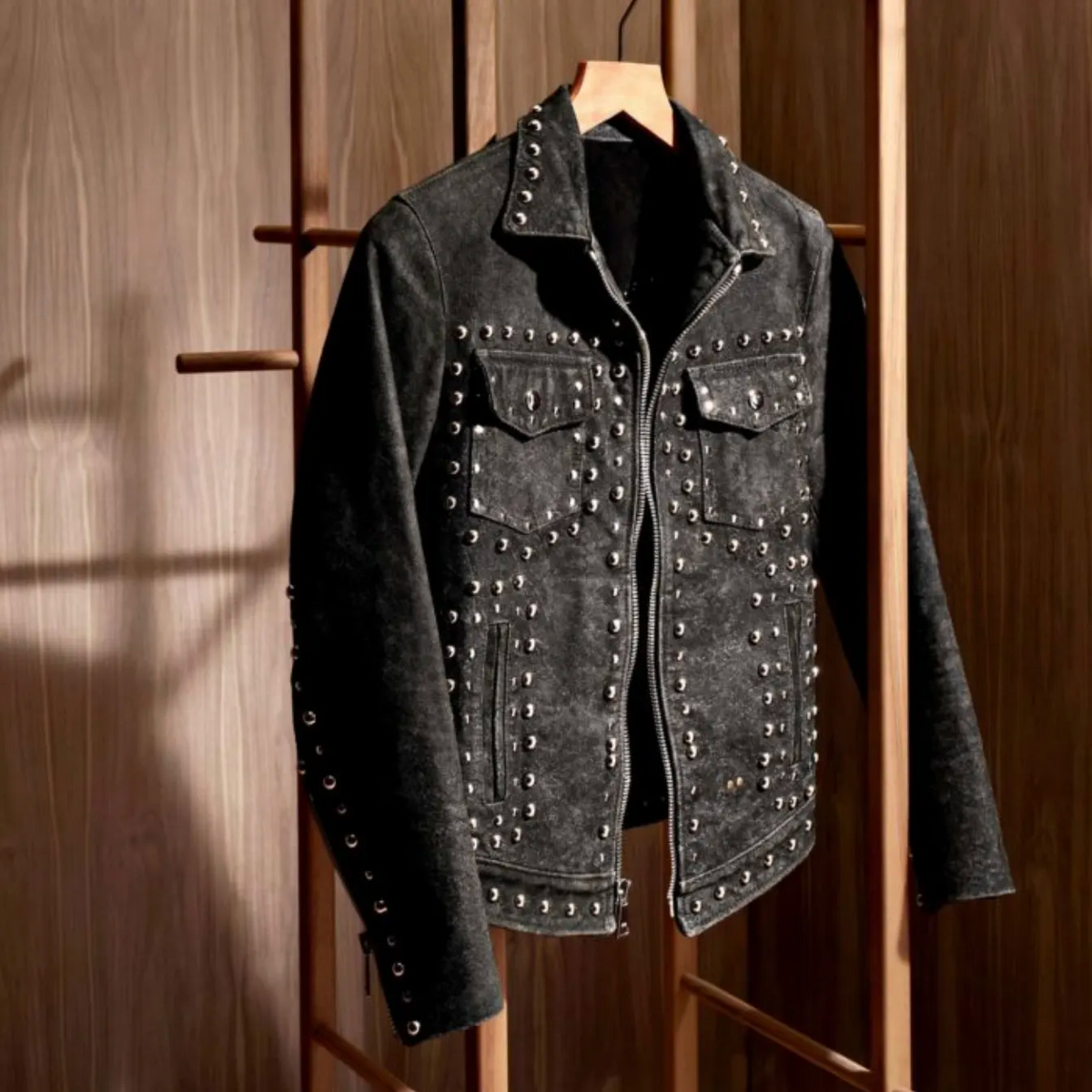 Image of a studded Savas jacket on a hanger.