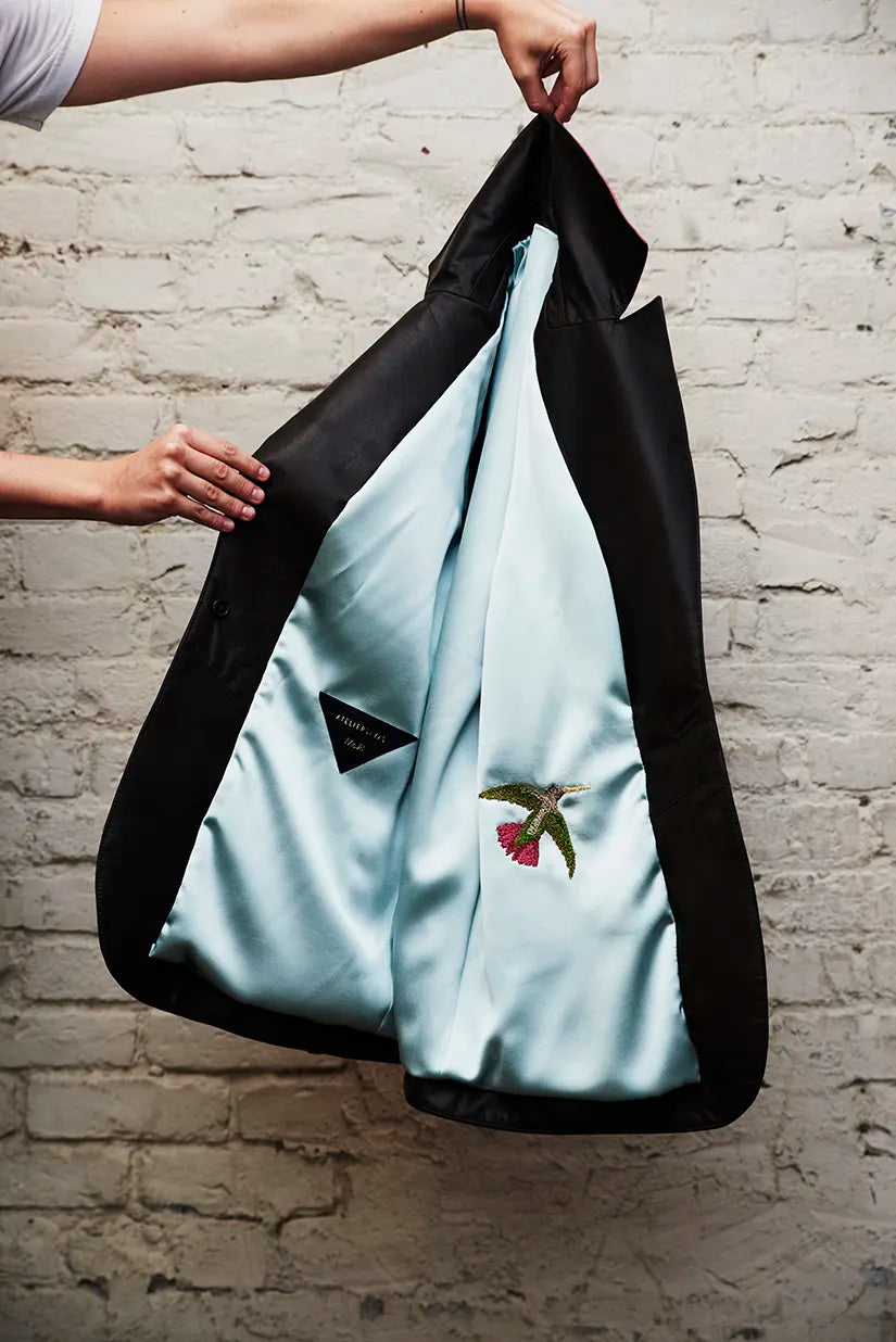 Image of a person's hands displaying the lining of a Savas jacket.
