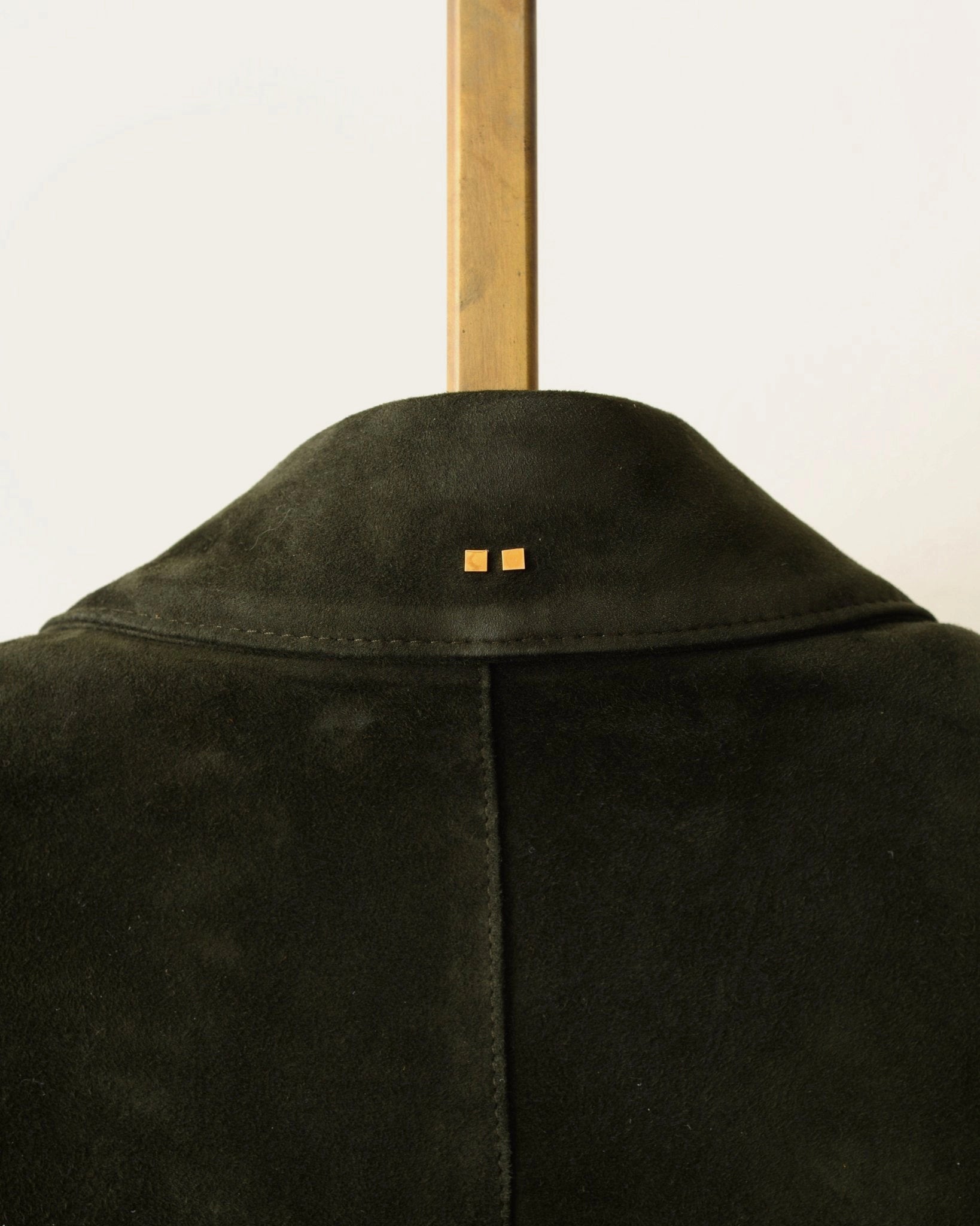 artisan-made details of hunter green bomber jacket with custom hardware by luxury designer savas in nashville tennessee