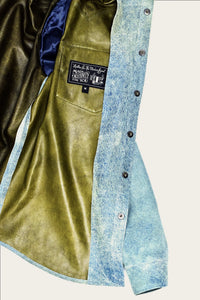 detail of interior of artisan-made mens luxury shirt jacket in indigo blue genuine italian leather with handmade snaps by luxury menswear designer savas in nashville tennessee