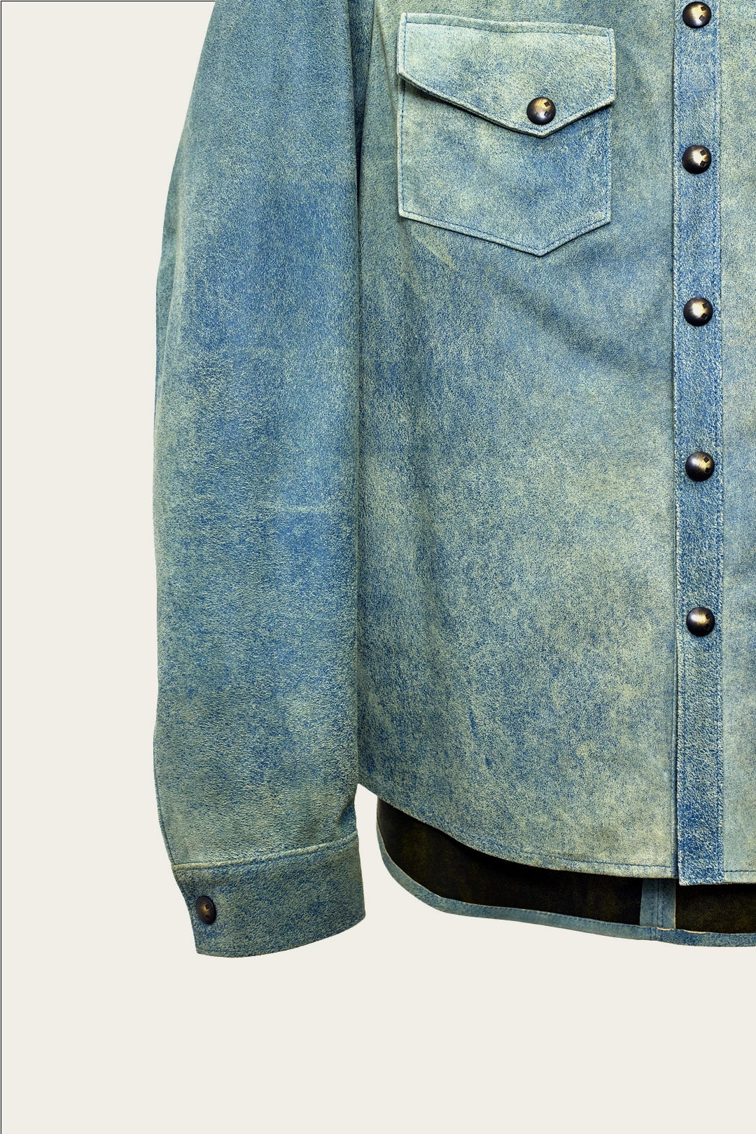 close up of sleeve and pockets of mens luxury shirt jacket in indigo blue genuine leather with handmade snaps by luxury menswear designer savas in nashville tennessee