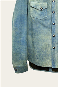 close up of sleeve and pockets of mens luxury shirt jacket in indigo blue genuine leather with handmade snaps by luxury menswear designer savas in nashville tennessee