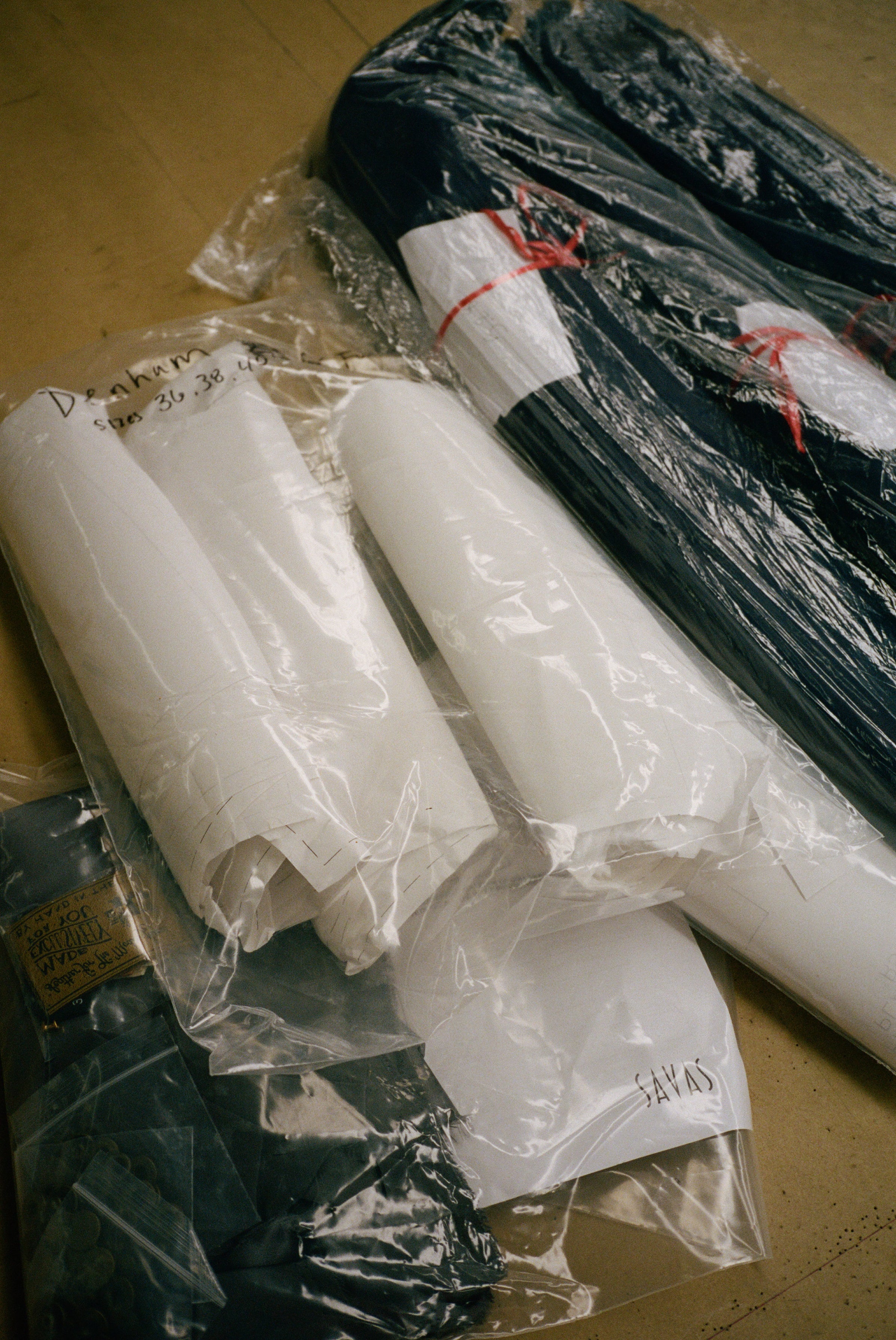 Image of polyester bags full of jacket hardware.