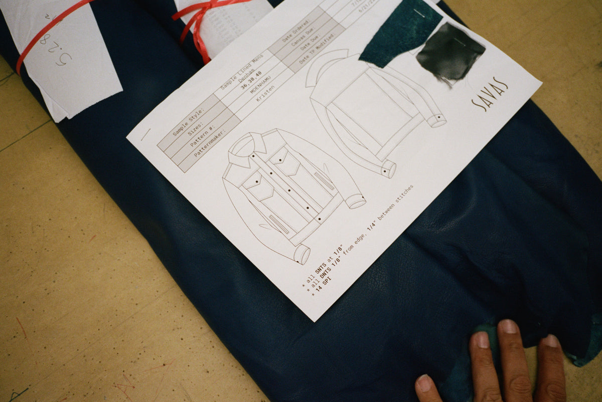 Image of hands examining a jacket spec sheet.