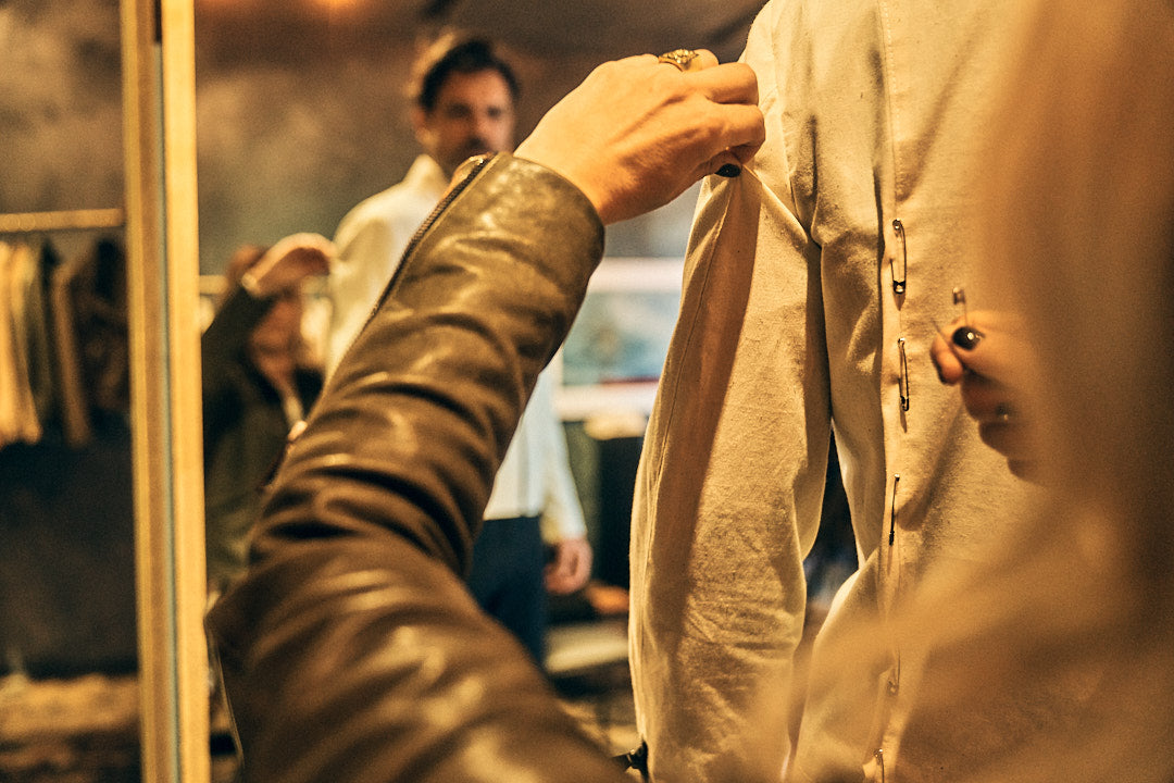 Image of Savannah's hands working on a canvas jacket mockup.