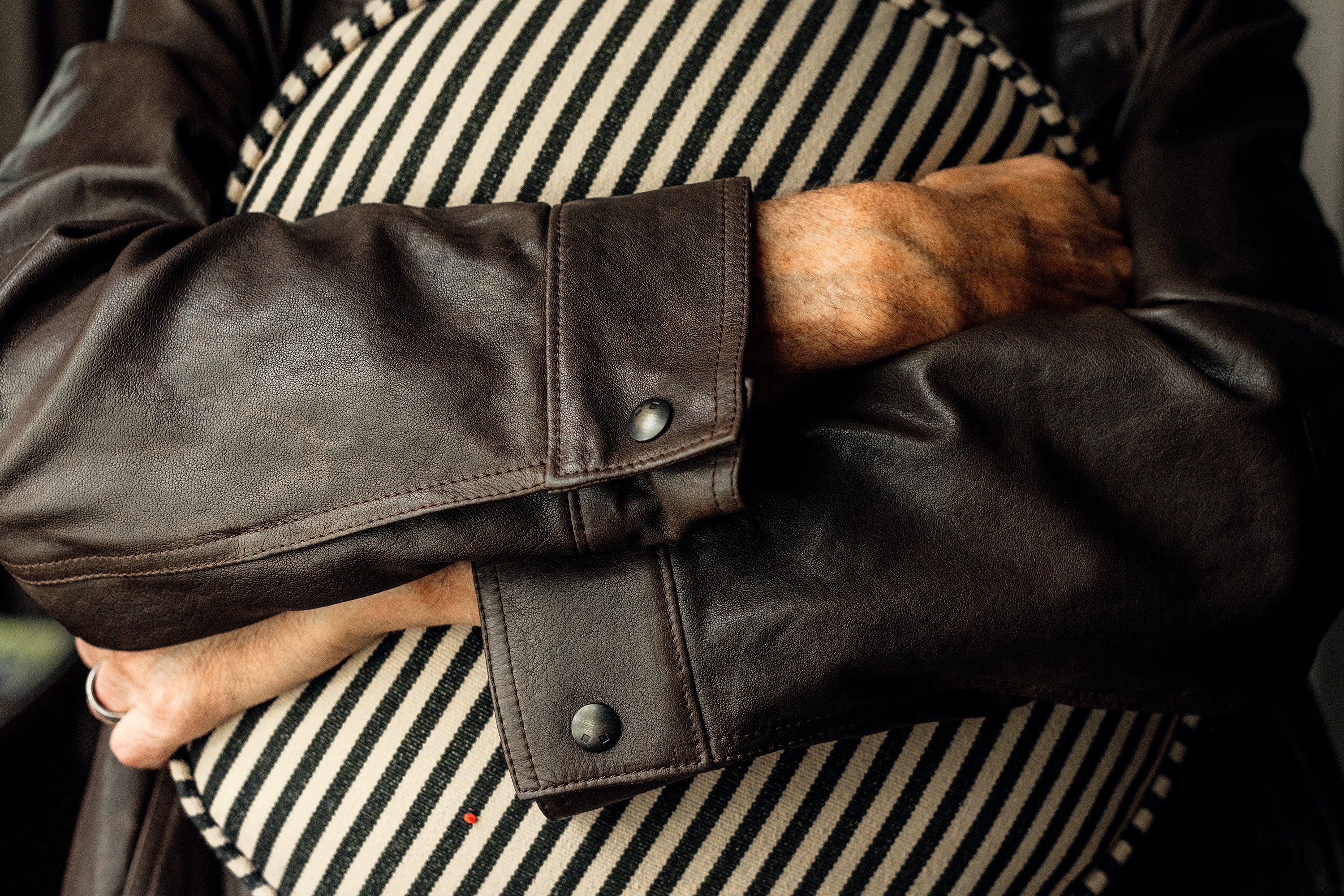 Denham jacket with four body pockets, antique brass logo snaps, and durable double needle stitching; lined with Bemberg fabric for comfortable, year-round wear.