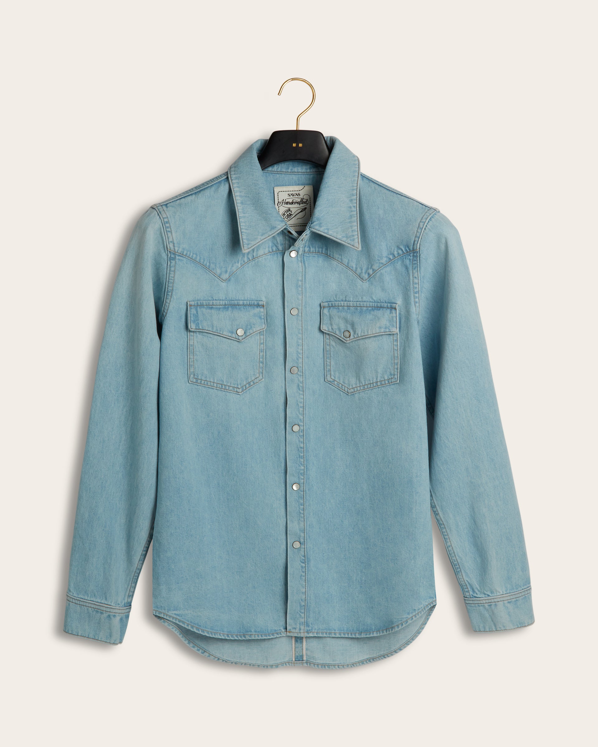 Front view of Savas pale blue Allen Denim Shirt with western style yoke, two chest pockets and ivory snap buttons