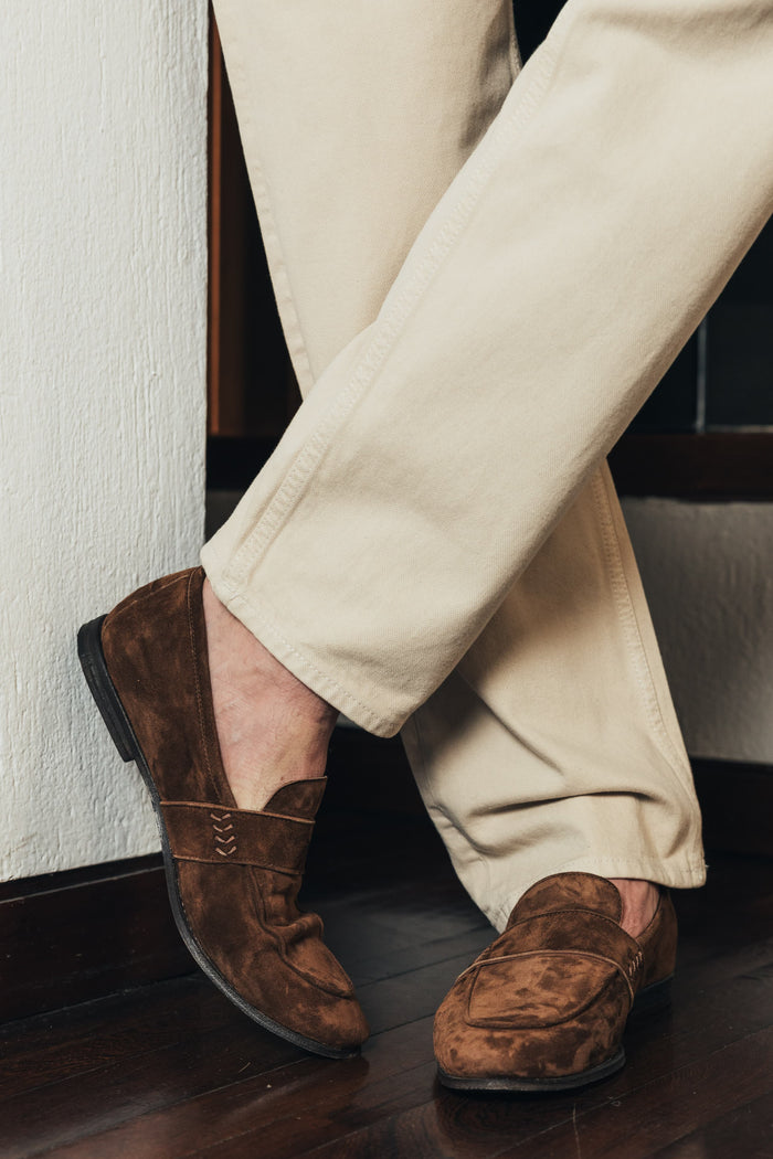 Model wears The Coyle suede loafer in Cedar brown. Made in Italy. Designed by Savas. 