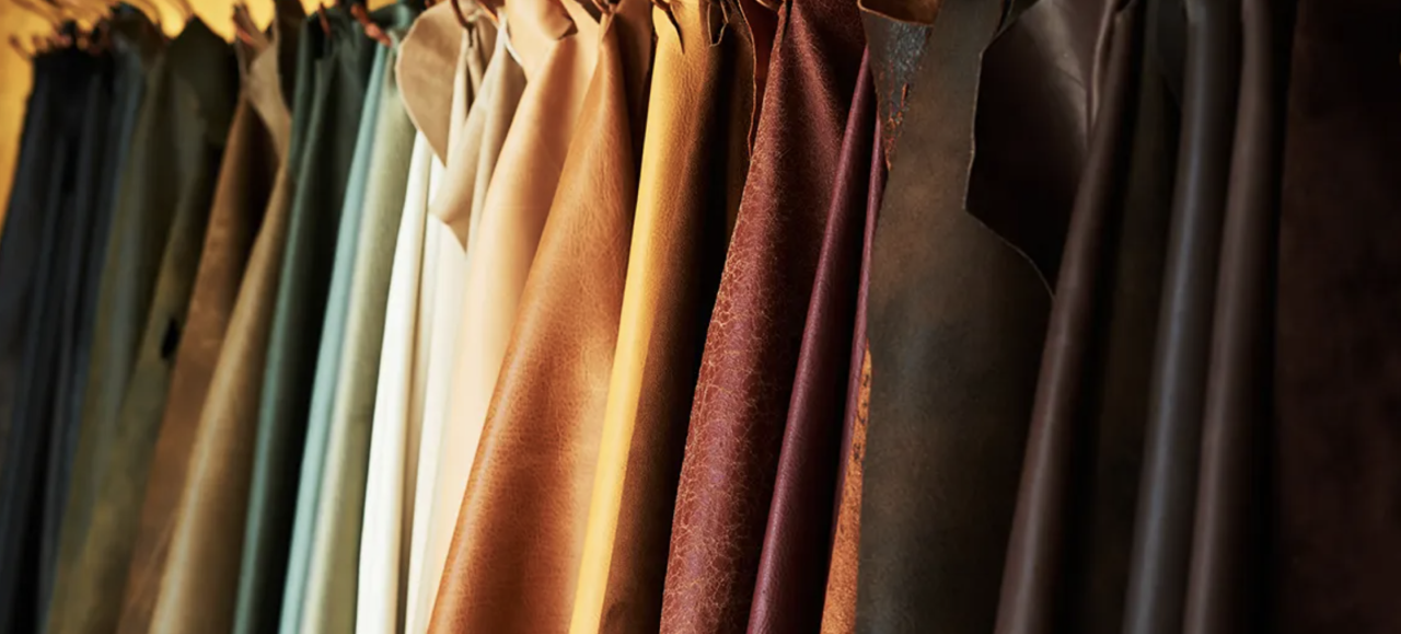 Image of Vari-colored leathers hung on a rack.