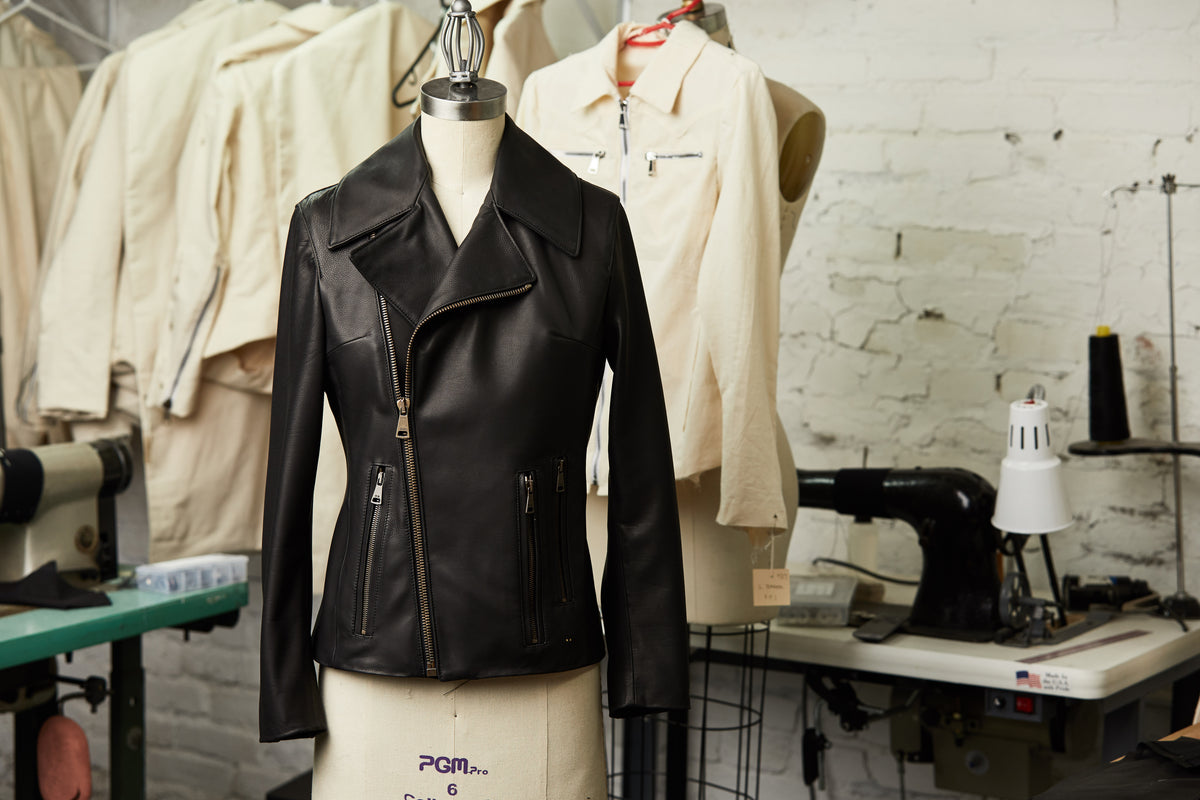 Image of a Savas jacket on a mannequin surrounded by the Savas workshop.