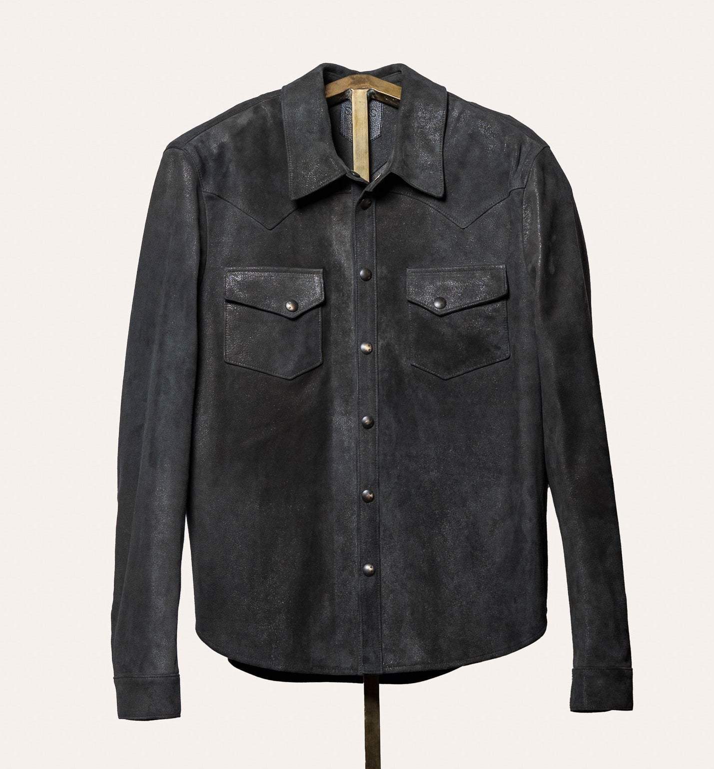 Dark gray suede shirt on a mannequin against a white background