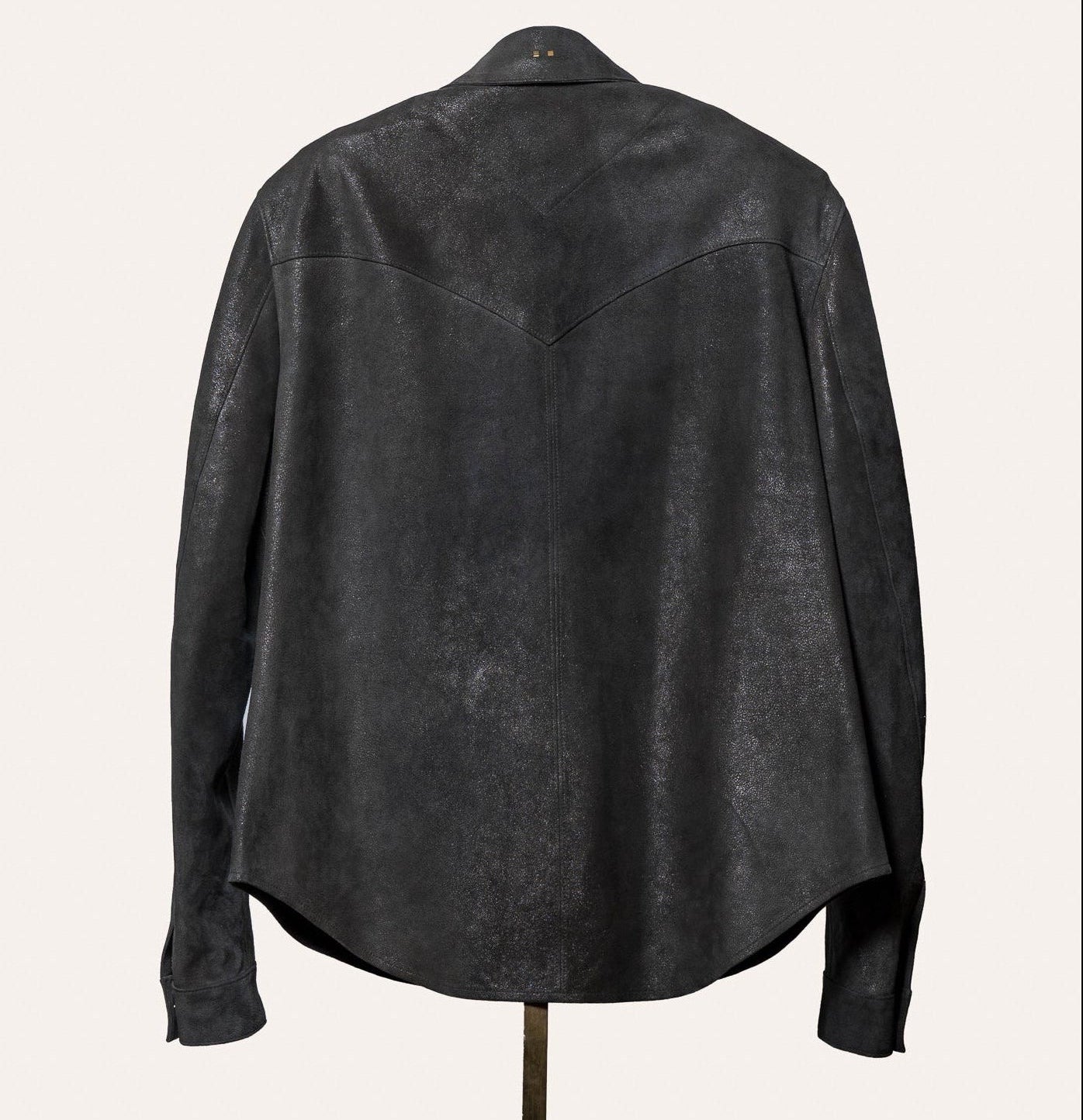 Tailored dark gray suede shirt for men, modeled on a mannequin, luxury menswear piece.