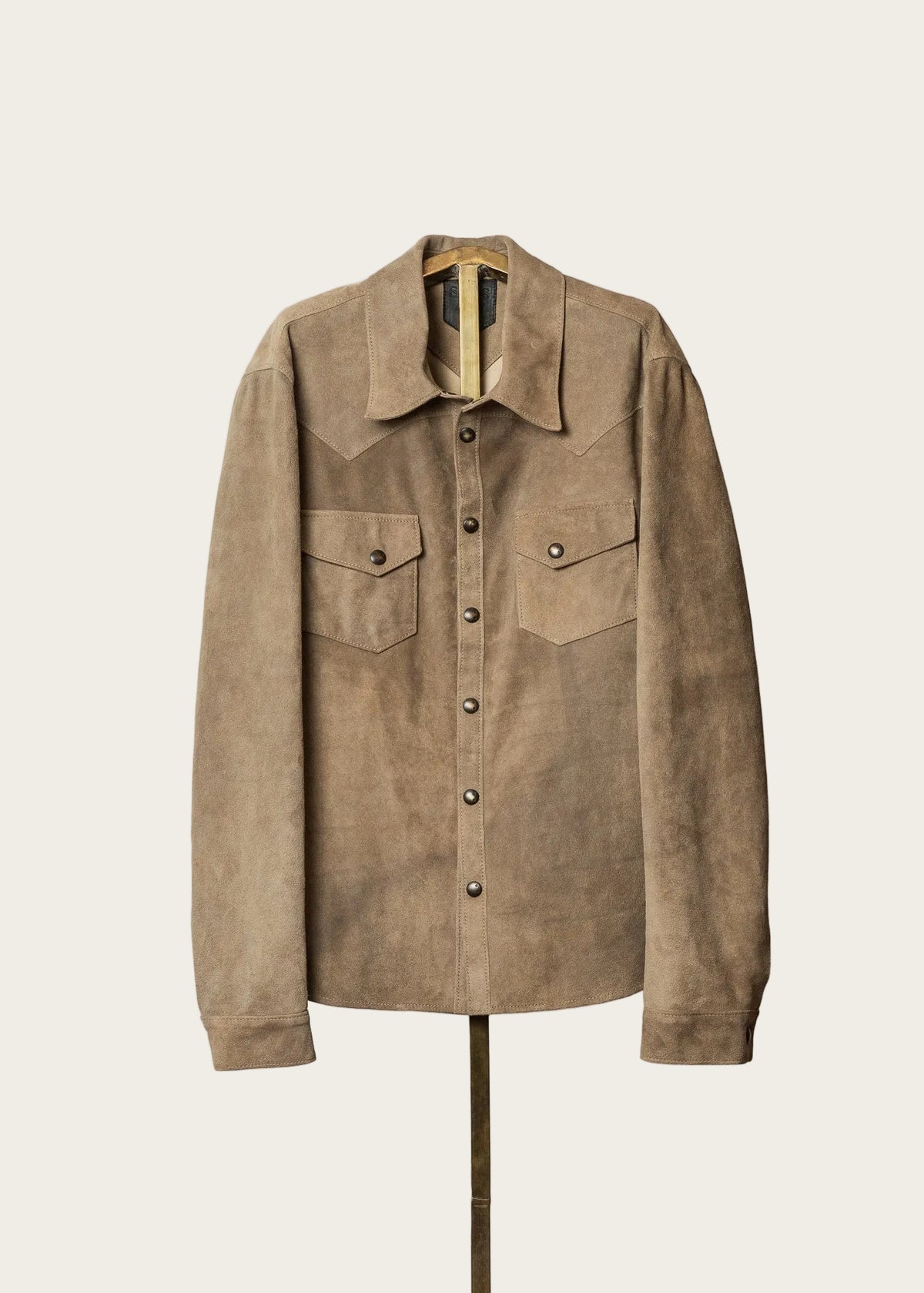 Brown suede jacket on a mannequin against a white background