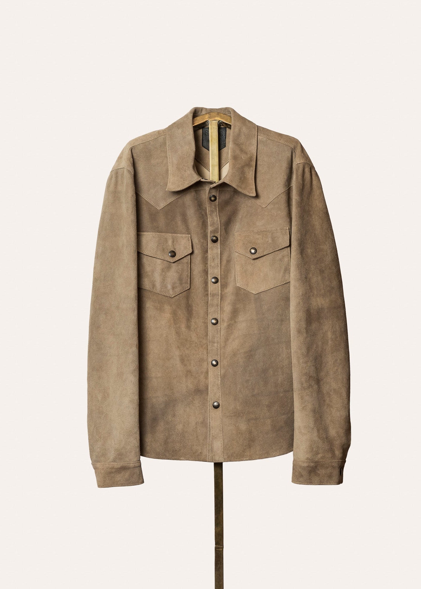 Brown suede jacket on a mannequin against a white background