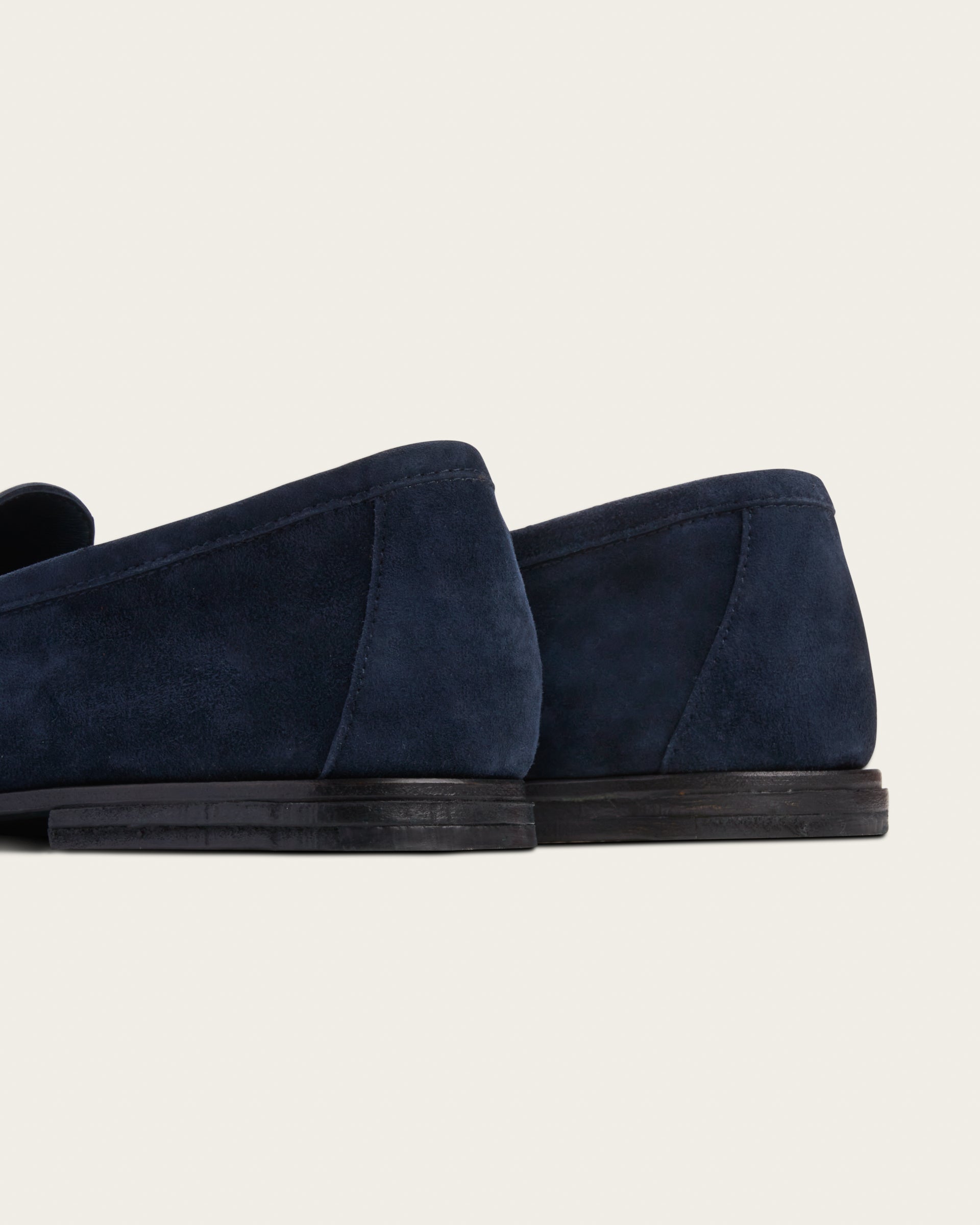 he Coyle sapphire suede loafers, rear three-quarter view showing hand-stacked leather heel and 4mm buffalo sole