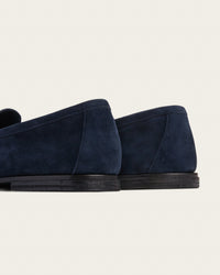 he Coyle sapphire suede loafers, rear three-quarter view showing hand-stacked leather heel and 4mm buffalo sole