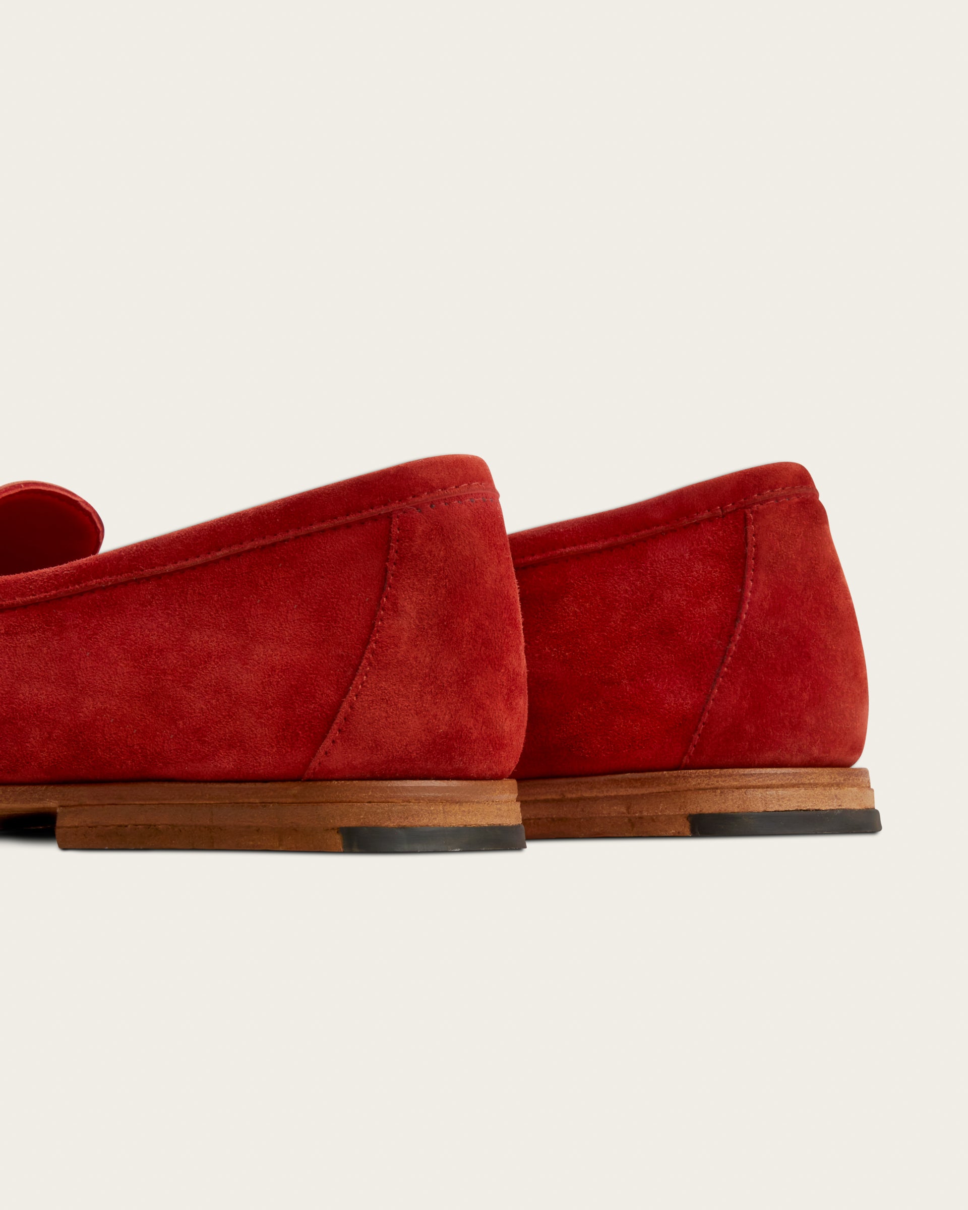 The Coyle saffron suede loafer, close back view of hand-stacked leather heel