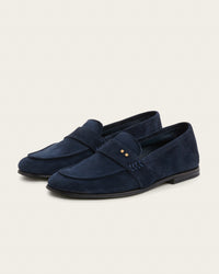 The Coyle sapphire suede loafer, three-quarter angle showing Two Dots brass rivets and napped suede finish