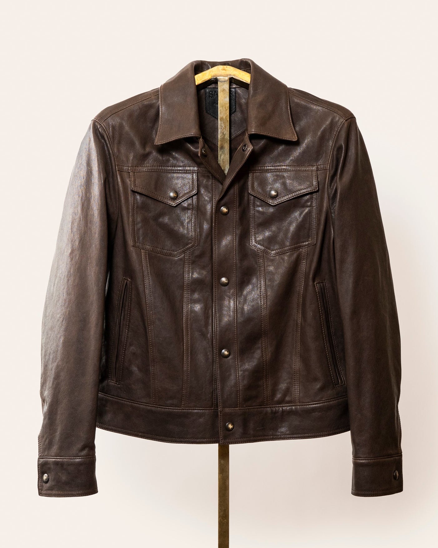 A softly tailored black lamb leather jacket with a clean, versatile silhouette, gunmetal hardware, and smooth lining. Designed for everyday wear, adaptable from casual to refined styling.