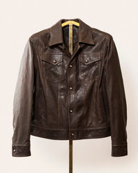A softly tailored black lamb leather jacket with a clean, versatile silhouette, gunmetal hardware, and smooth lining. Designed for everyday wear, adaptable from casual to refined styling.
