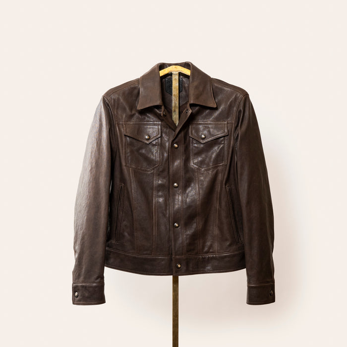 A softly tailored black lamb leather jacket with a clean, versatile silhouette, gunmetal hardware, and smooth lining. Designed for everyday wear, adaptable from casual to refined styling.