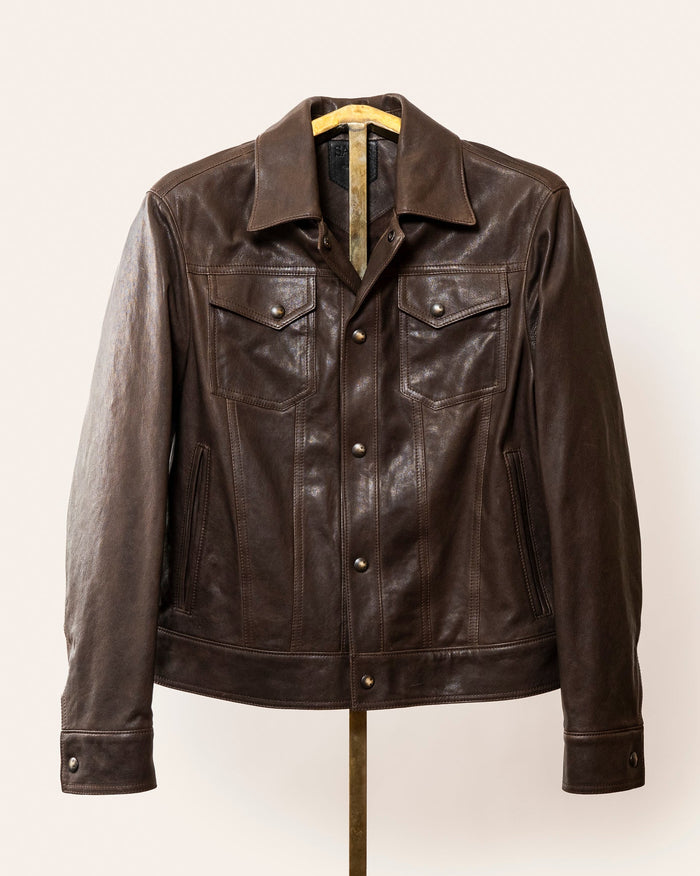 A softly tailored black lamb leather jacket with a clean, versatile silhouette, gunmetal hardware, and smooth lining. Designed for everyday wear, adaptable from casual to refined styling.