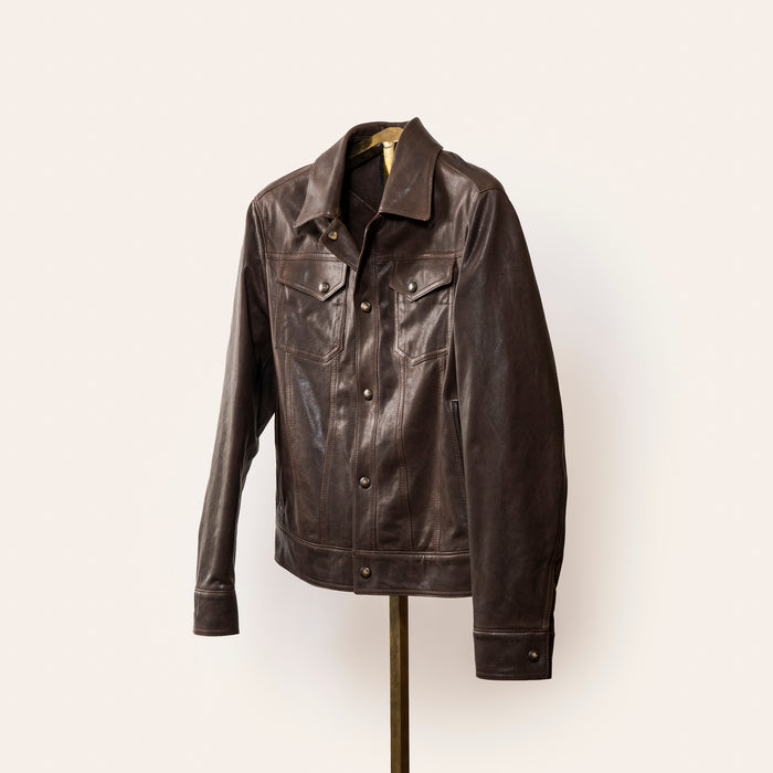 The Denham jacket by Savas in 100% lamb leather with gunmetal logo hardware, softly tailored fit, and Bemberg lining. A versatile black leather jacket that styles effortlessly with jeans or trousers.