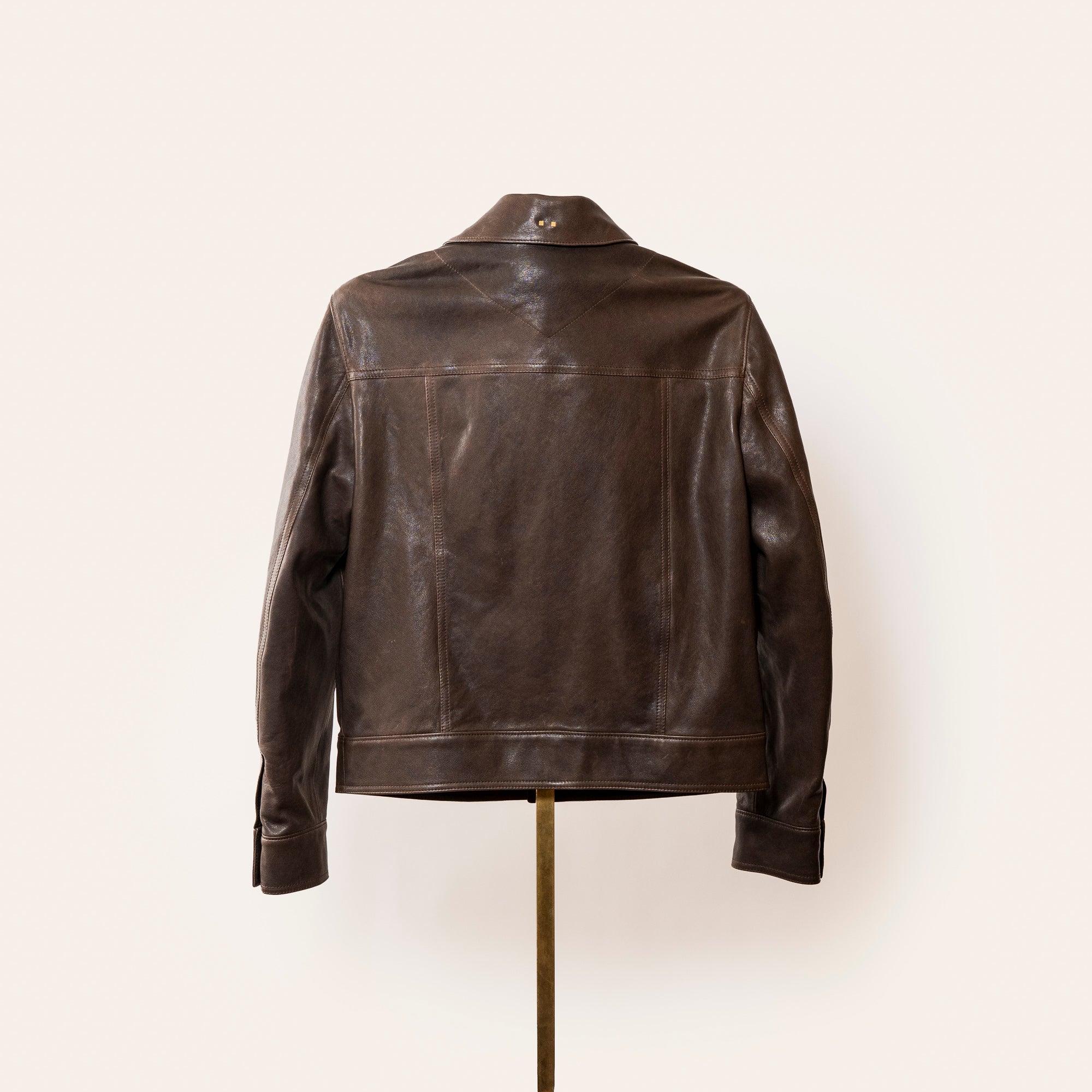 Luxury brown leather jacket, The Denham by Savas, featuring tailored cut, gunmetal logo hardware, and premium lining.