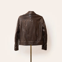 Luxury brown leather jacket, The Denham by Savas, featuring tailored cut, gunmetal logo hardware, and premium lining.
