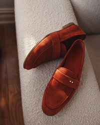 The Coyle saffron suede loafer in a lifestyle setting, showing warm tone of Italian calf suede and Two Dots detailing