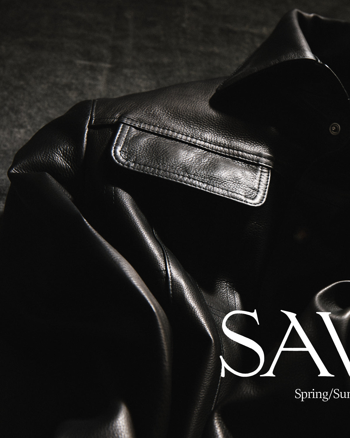 Black Leather Savas Jacket on textured background with the words "Savas Spring Summer 2026"