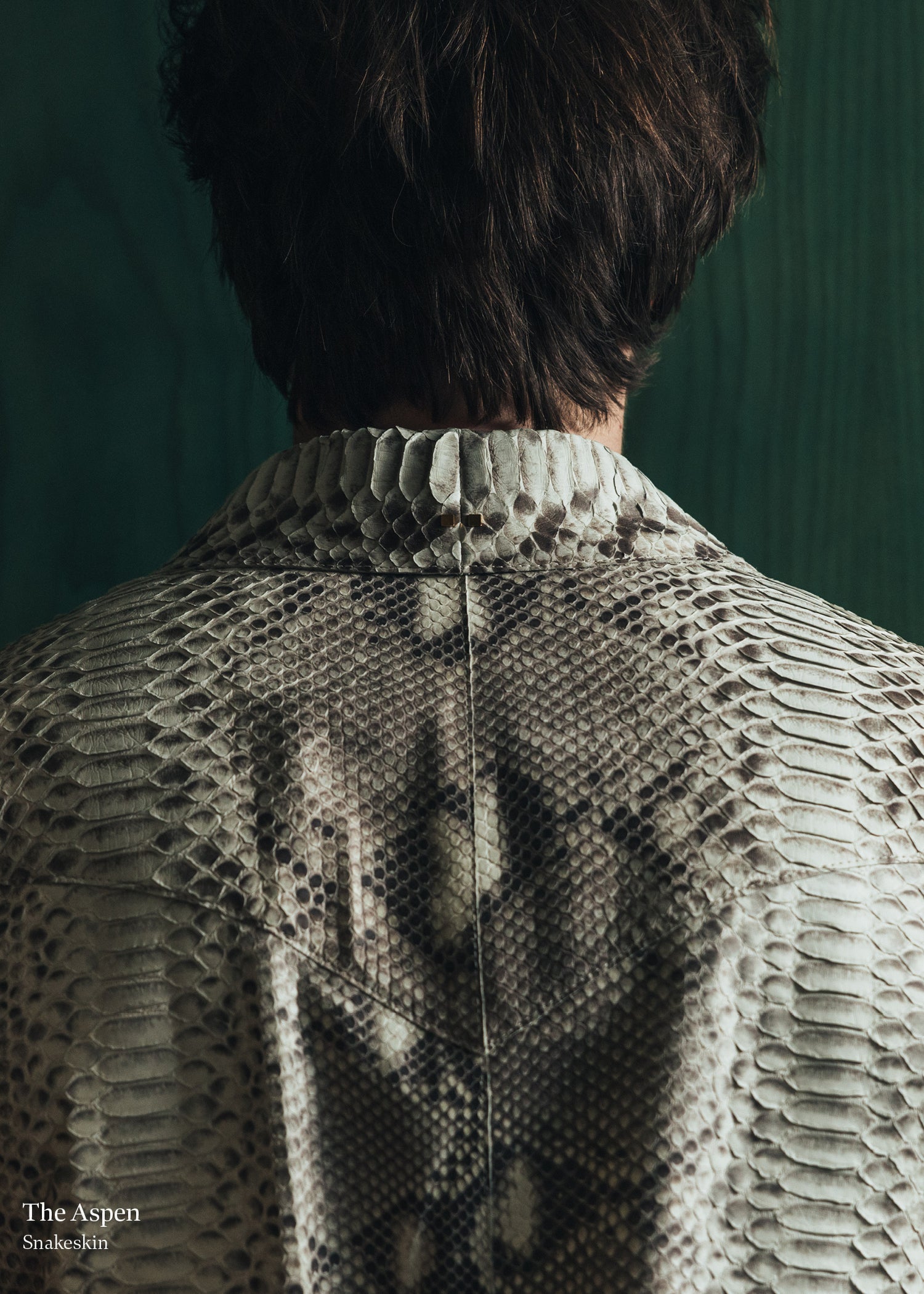 Person wearing a textured knit sweater with a dark background