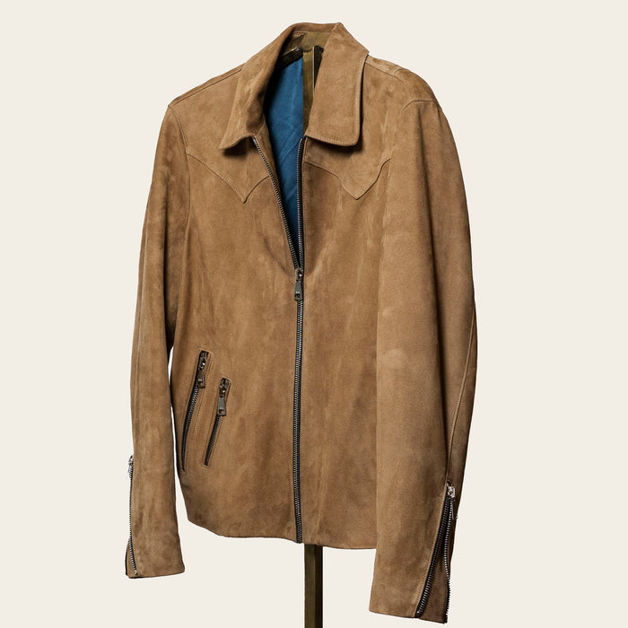 The Legend suede jacket in a rich, neutral tone, featuring a slim tailored fit, subtle western shoulder yoke, three exterior zippered pockets, and adjustable sleeve gussets. Made from lightweight, malleable calf suede designed for timeless style and durability.